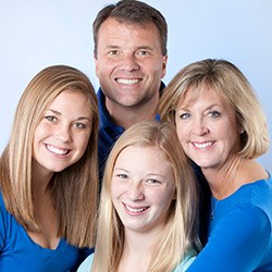 Smiling mother and father and two daughters