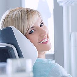 Smiling woman in dnetal chair