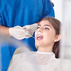 Woman receiving oral cancer screening