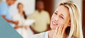 Woman holding jaw in pain