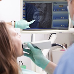 Woman and dnetist looking at intraoral photos