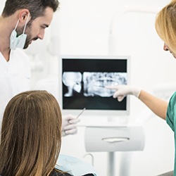 Dentist and patient looking at x-rays